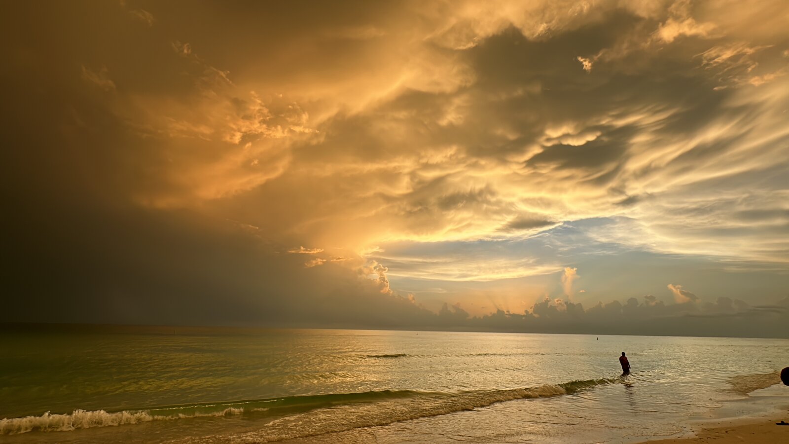 Dramatic golden storm clouds sunset over the Gulf