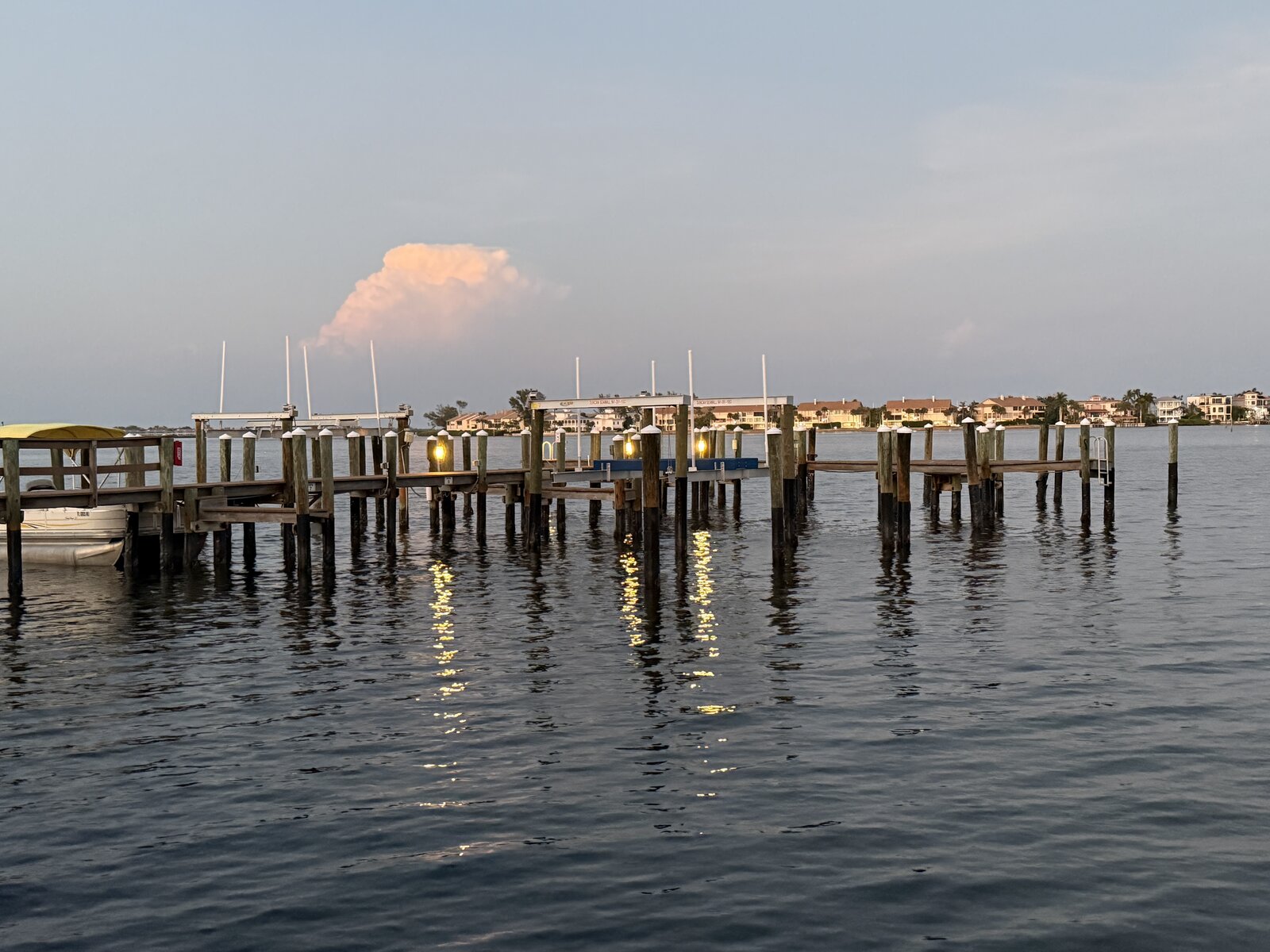 Dock with lantern lights at dusk over Sarasota Bay