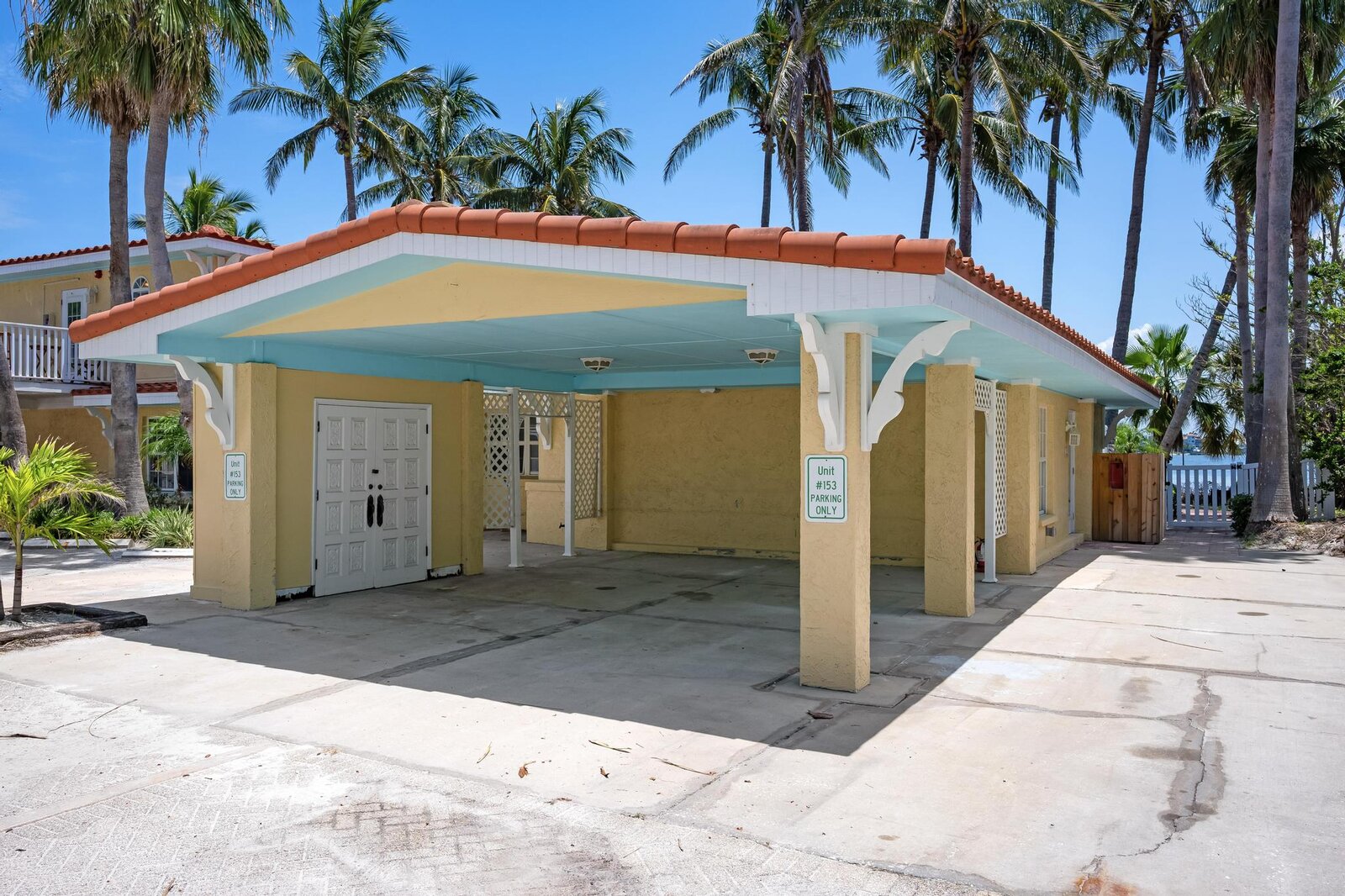 Exterior of ground-floor unit #153 with covered parking
