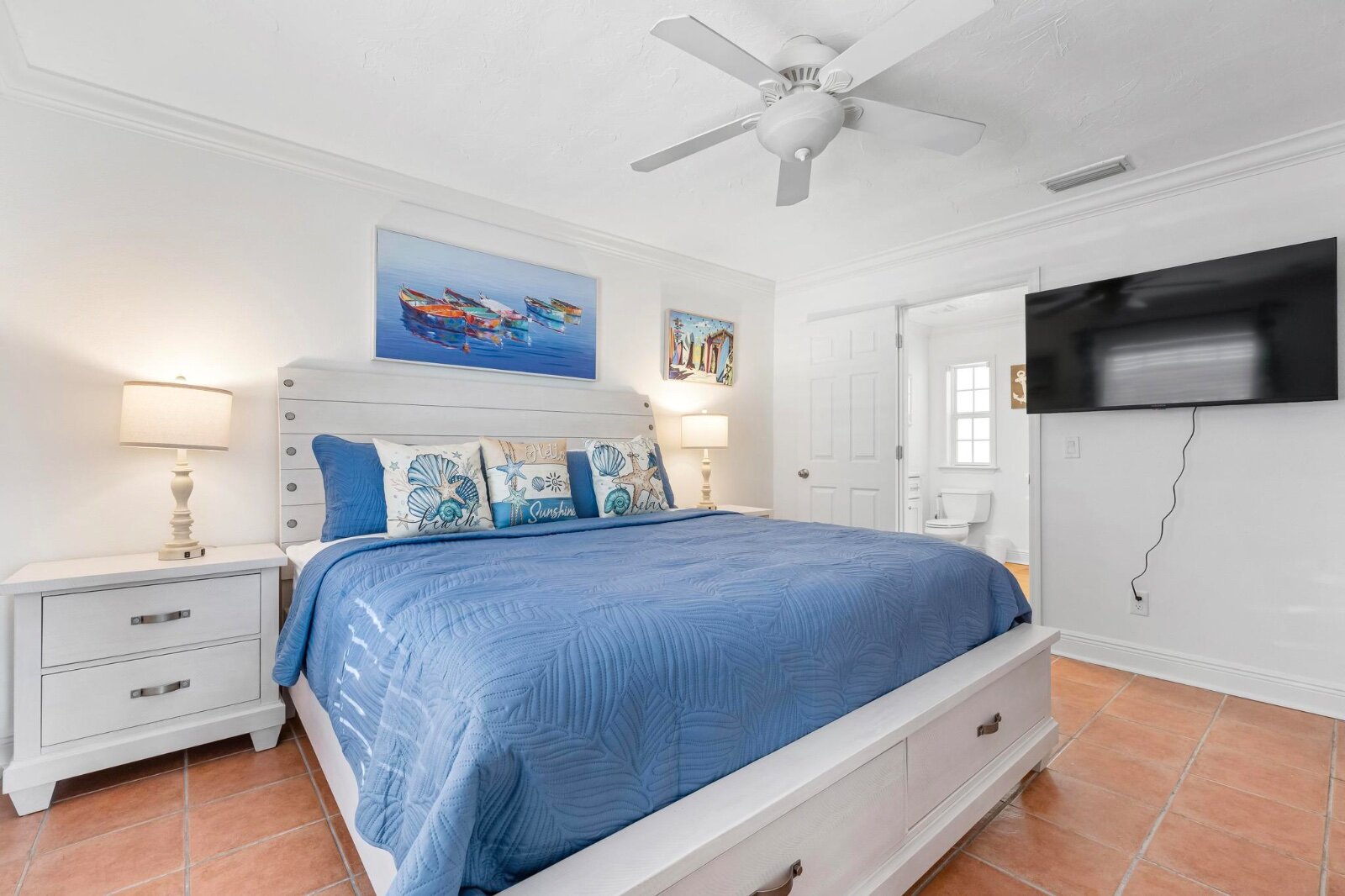 King master suite with blue bedding and coastal decor