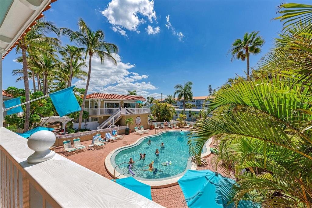 Heated pool with bay views at Tortuga Inn Beach Resort
